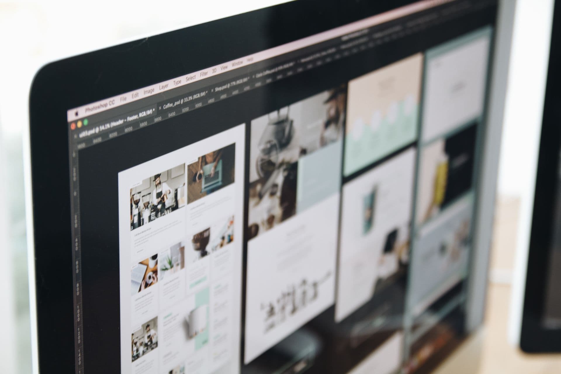 Web design work displayed on a computer screen in a workspace
